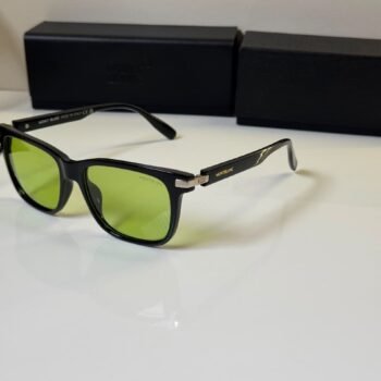 black rectangular sunglasses with green tinted lenses