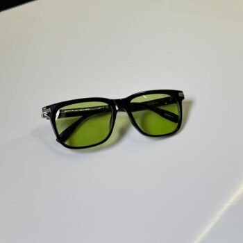 black rectangular sunglasses with green tinted lenses