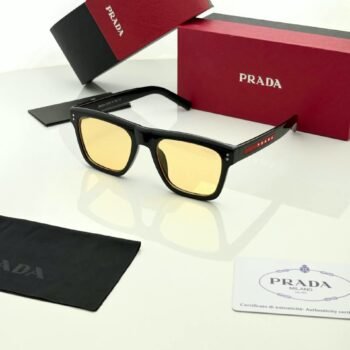 Black rectangular sunglasses with yellow tinted lenses and red temple accents