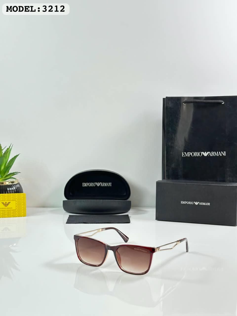 Brown Frame Sunglasses – Gold Tone Details (1) Brown rectangular sunglasses with gradient-style lenses and gold-tone temples