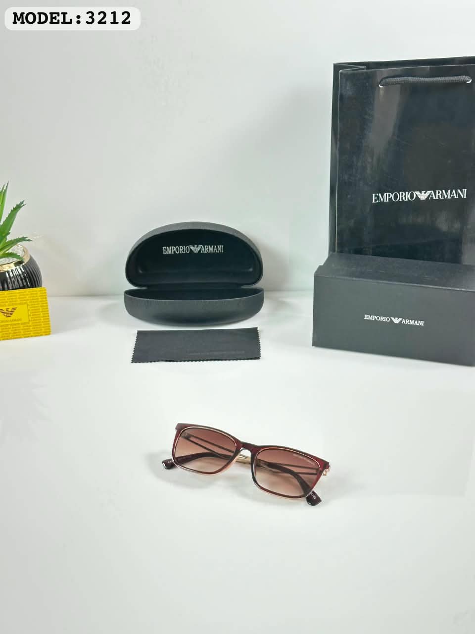 Brown Frame Sunglasses – Gold Tone Details (2) Brown rectangular sunglasses with gradient-style lenses and gold-tone temples