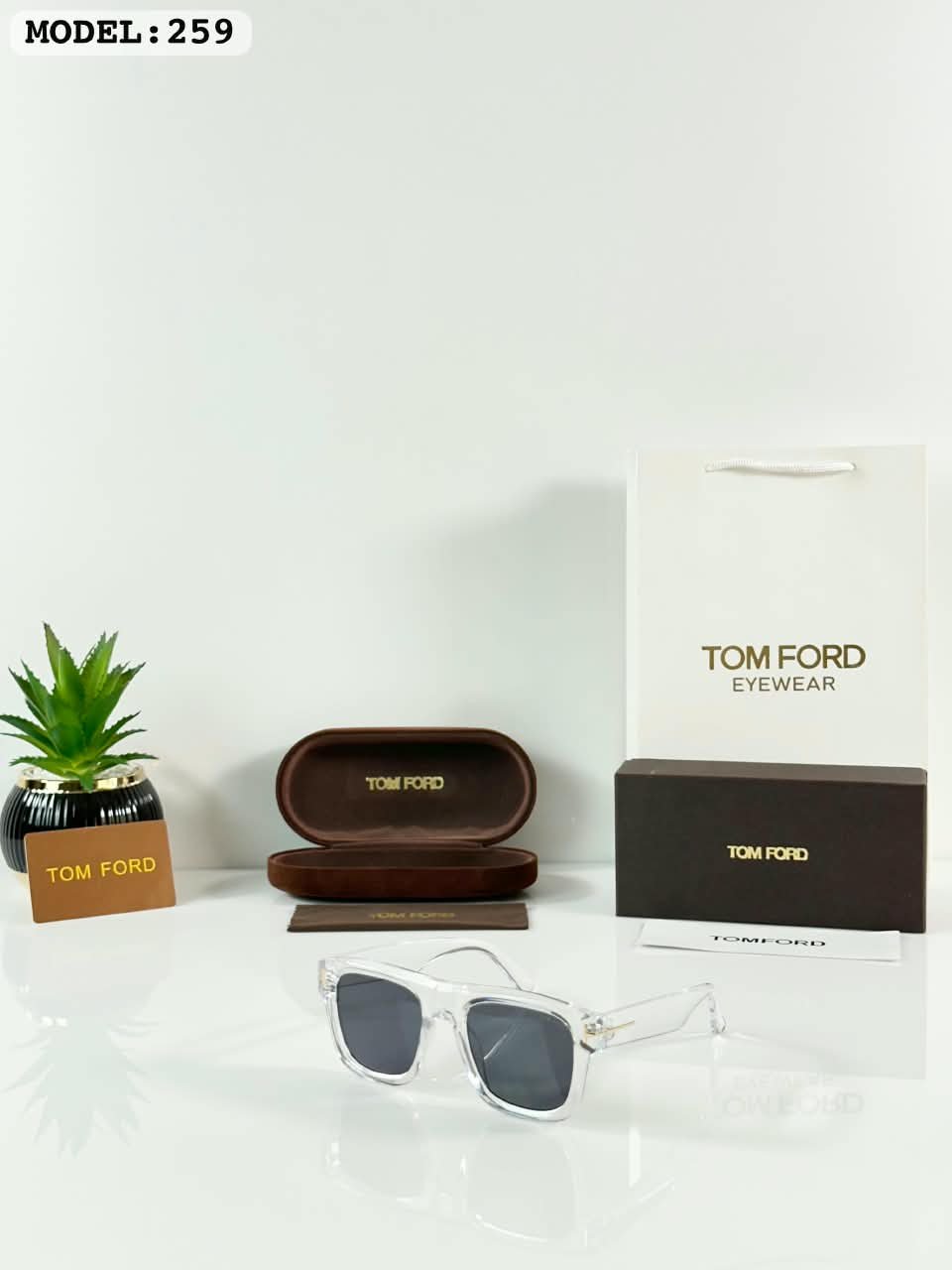 Clear Frame Sunglasses – Black Tinted Lenses (2) Clear frame sunglasses with rectangular black tinted lenses and transparent temples