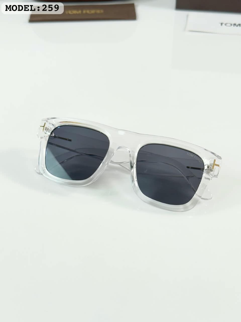 Clear Frame Sunglasses – Black Tinted Lenses (3) Clear frame sunglasses with rectangular black tinted lenses and transparent temples
