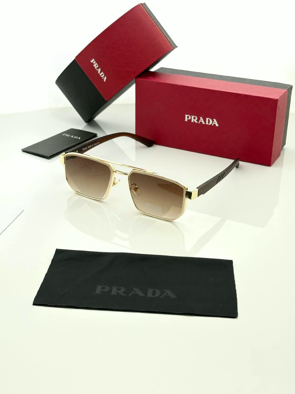 Rectangular Sunglasses – Gold Frame Brown Gradient Lenses (1) Rectangular gold-tone sunglasses with brown gradient lenses and dark temples
