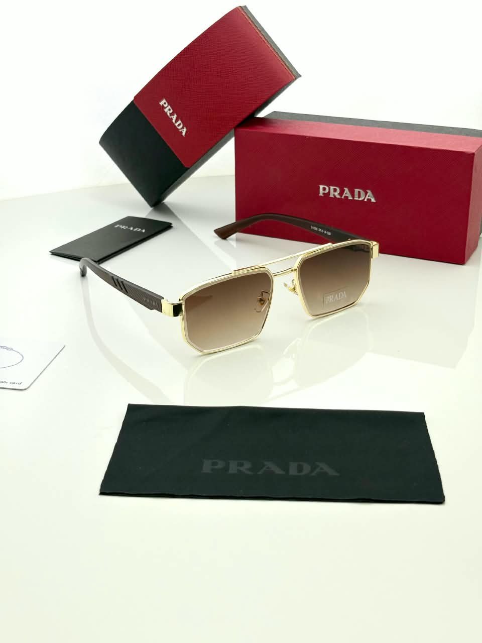 Rectangular Sunglasses – Gold Frame Brown Gradient Lenses (2) Rectangular gold-tone sunglasses with brown gradient lenses and dark temples