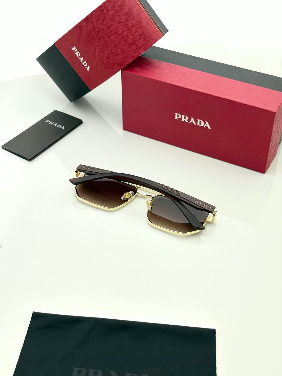 Rectangular Sunglasses – Gold Frame Brown Gradient Lenses (3) Rectangular gold-tone sunglasses with brown gradient lenses and dark temples