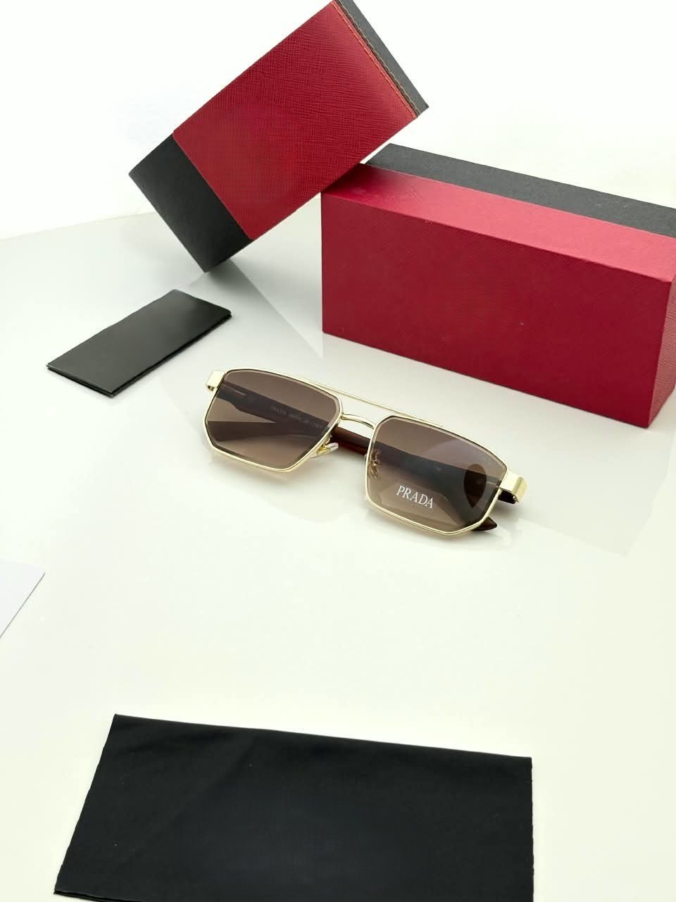 Rectangular Sunglasses – Gold Frame Brown Gradient Lenses (4) Rectangular gold-tone sunglasses with brown gradient lenses and dark temples