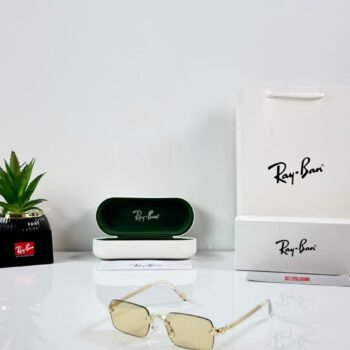 Rimless rectangular sunglasses with a gold-tone metal frame and light yellow lenses