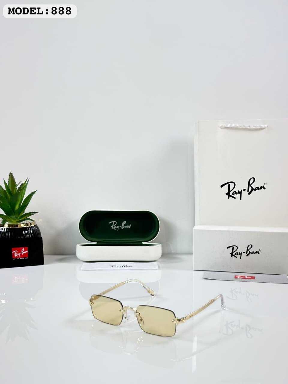 Rimless Rectangle Sunglasses – Gold Frame with Light Yellow Lenses (1) Rimless rectangular sunglasses with a gold-tone metal frame and light yellow lenses