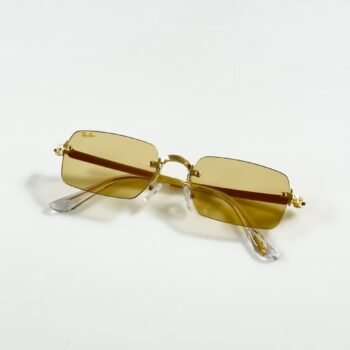 Rimless rectangular sunglasses with a gold-tone metal frame and light yellow lenses