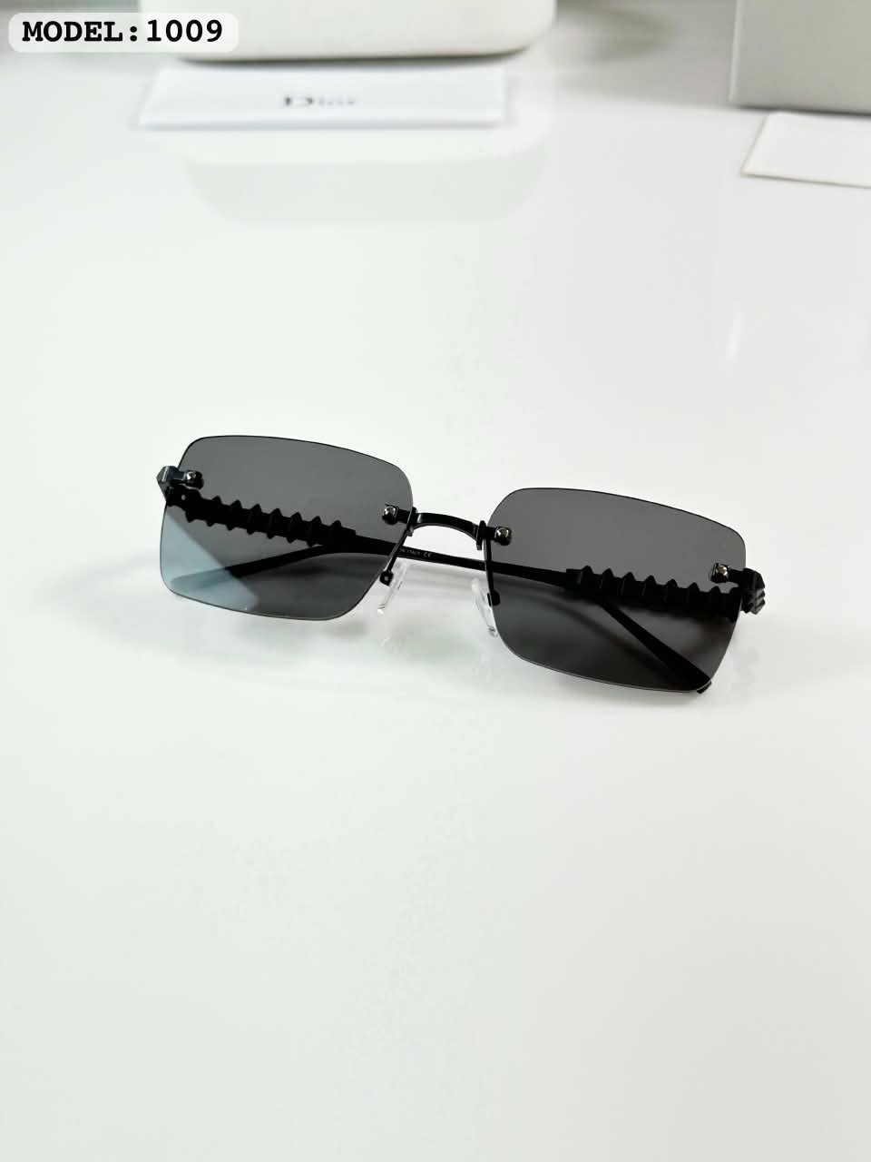Rimless Sunglasses – Black Lenses with Textured Temples (3) Black rimless rectangular sunglasses with dark lenses and textured temples
