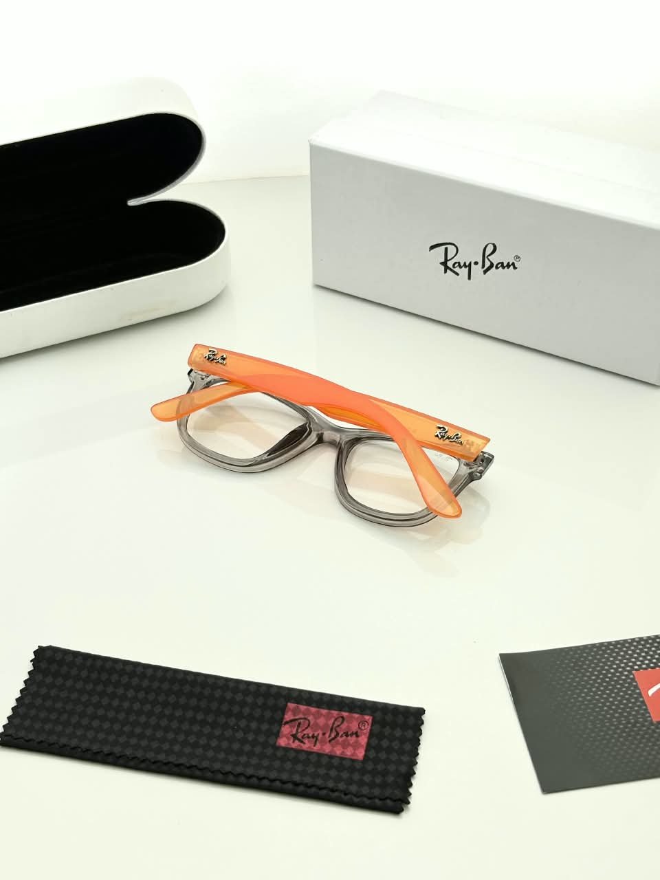 Transparent Grey Eyeglass Frames – Orange Temple Design (3) Transparent grey rectangular eyeglass frames with bright orange temples
