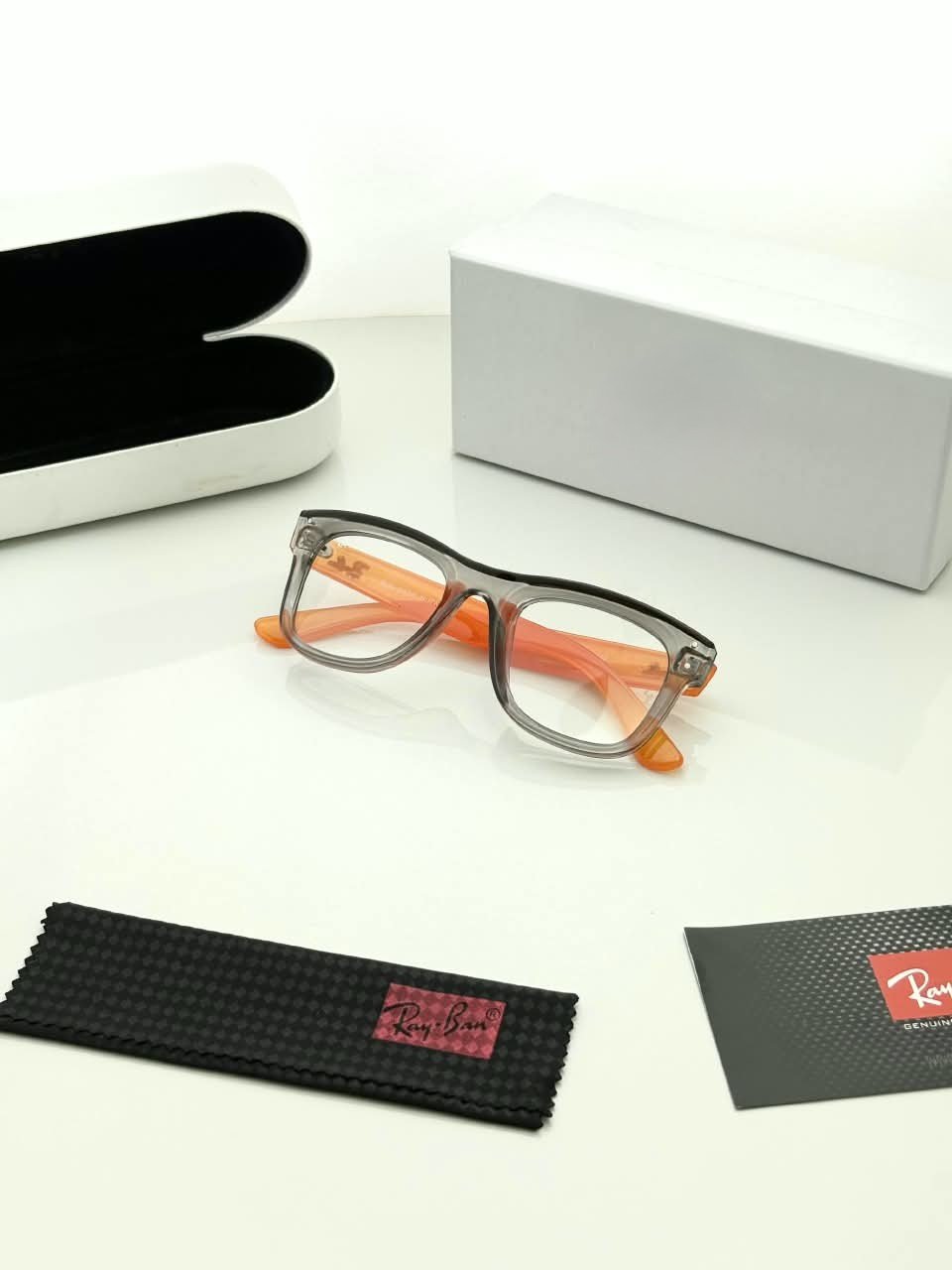 Transparent Grey Eyeglass Frames – Orange Temple Design (4) Transparent grey rectangular eyeglass frames with bright orange temples