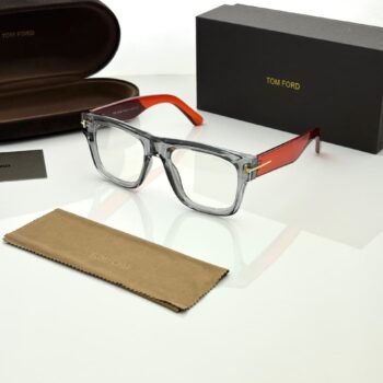 Transparent smoky grey rectangular eyeglass frames with red temples and gold-tone hinge details