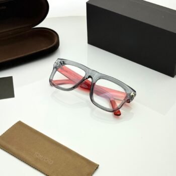 Transparent smoky grey rectangular eyeglass frames with red temples and gold-tone hinge details