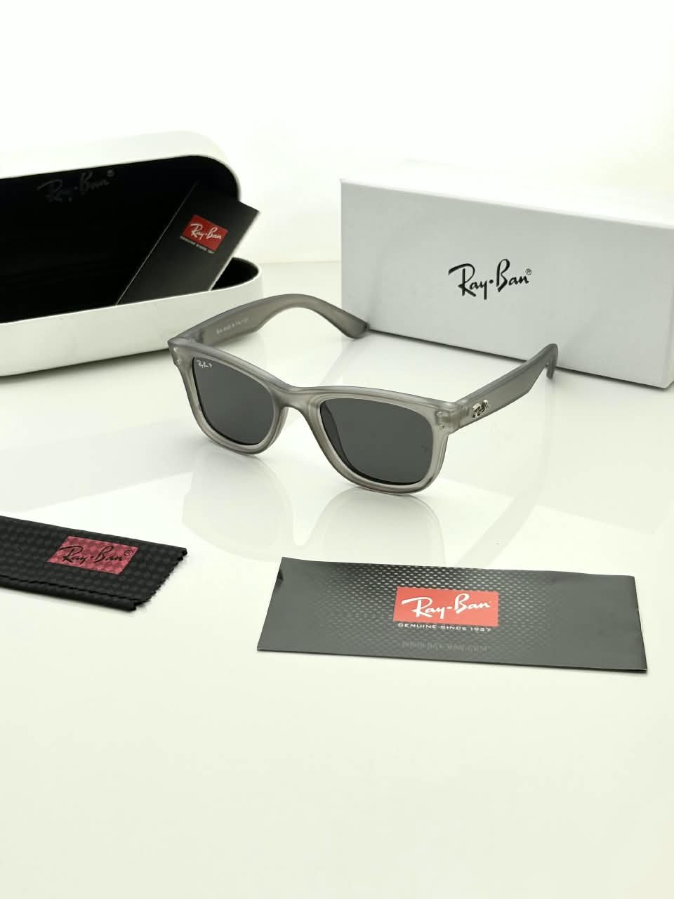 Transparent Grey Sunglasses – Dark Grey Lenses (1) Transparent grey sunglasses with dark grey lenses and softly squared frames