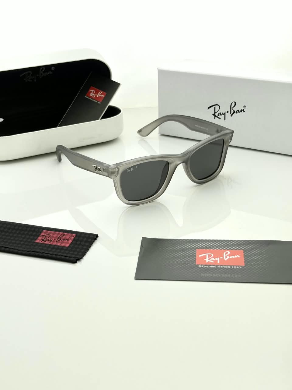 Transparent Grey Sunglasses – Dark Grey Lenses (2) Transparent grey sunglasses with dark grey lenses and softly squared frames