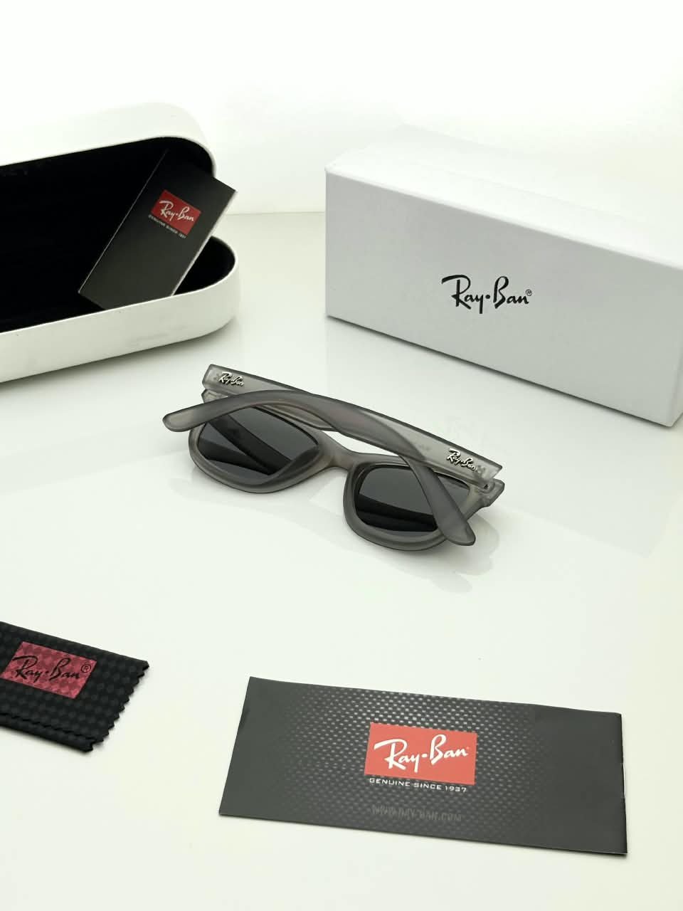 Transparent Grey Sunglasses – Dark Grey Lenses (3) Transparent grey sunglasses with dark grey lenses and softly squared frames