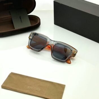 Transparent grey square sunglasses with dark gradient lenses and orange temple accents