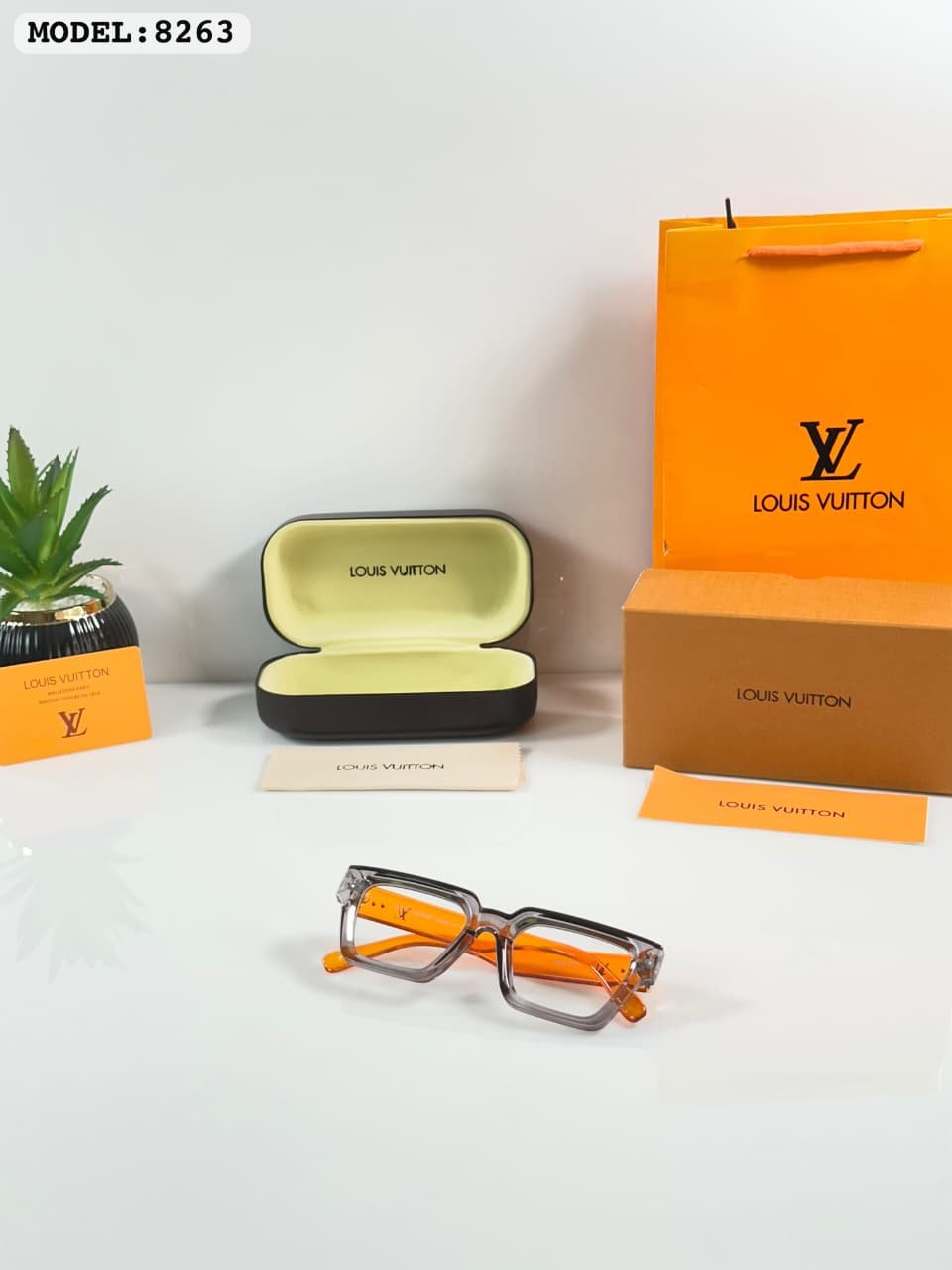 Transparent Square Glasses – Grey Frame with Orange Temples (2) Transparent smoky grey square glasses with bright orange temples and clear-looking lenses
